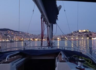 Kavala lighting up at dusk, from the bow
