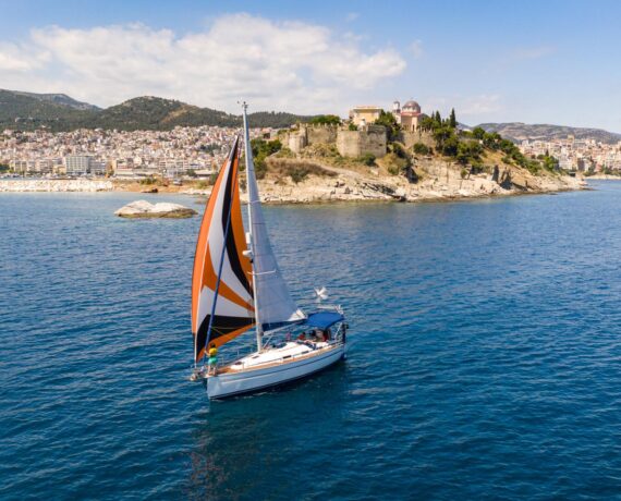 Pipit under sail in front of the old town of Kavala