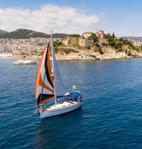 Pipit under sail in front of the old town of Kavala