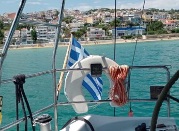 On deck, Greek flag flying